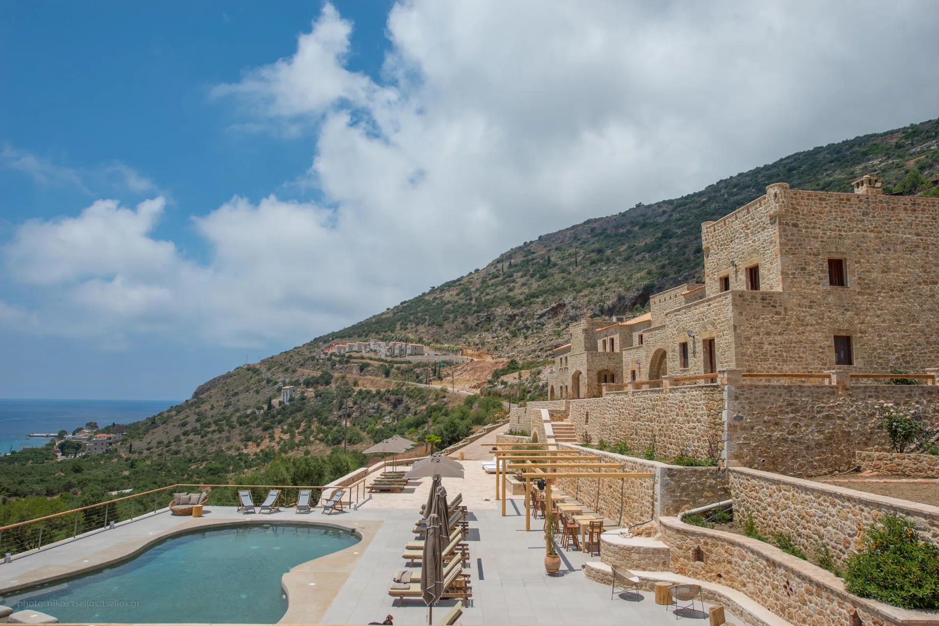 Outdoor pool area with loungers and Mediterranean greenery